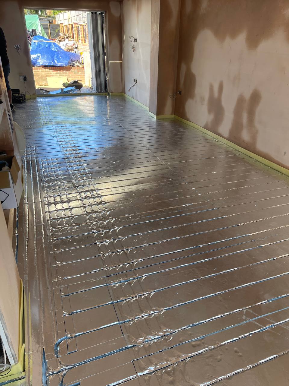 Wet underfloor heating installation in a North London extension