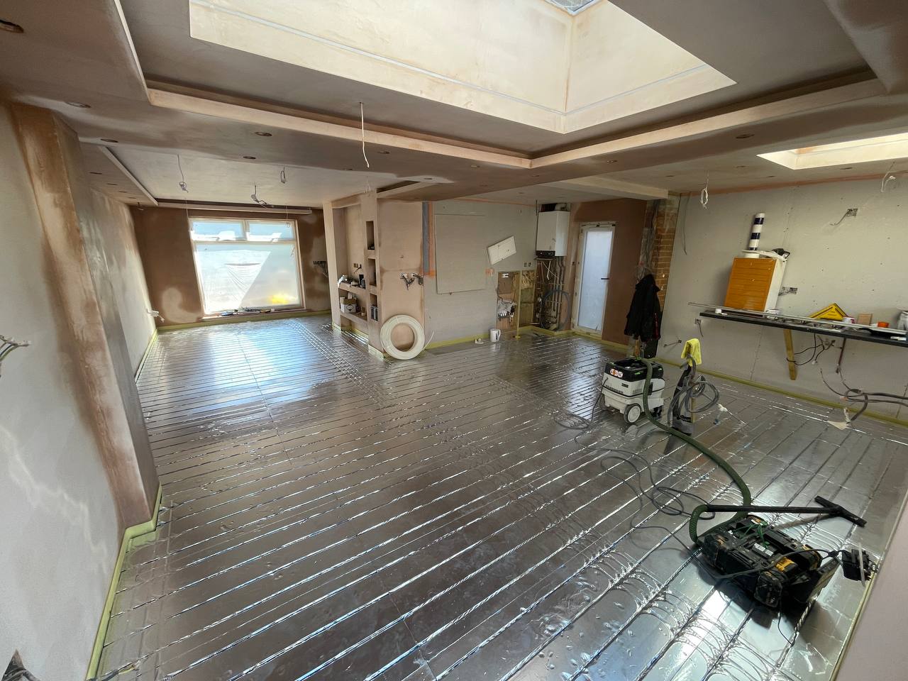Wet underfloor heating installation in a North London extension